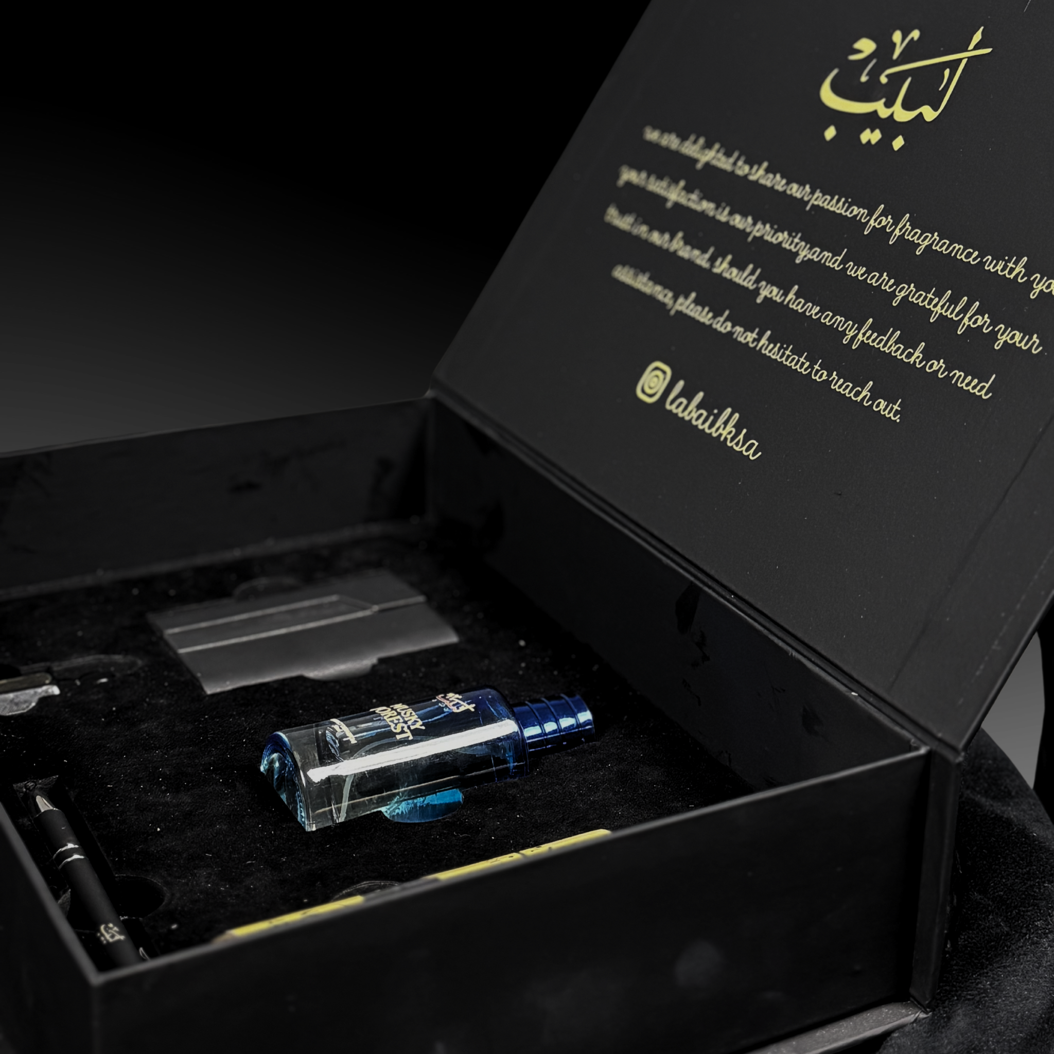 Labaib Premium Box featuring signature perfume, rich attar, body mist, leather card holder, and premium pen elegantly arranged for luxury gifting.